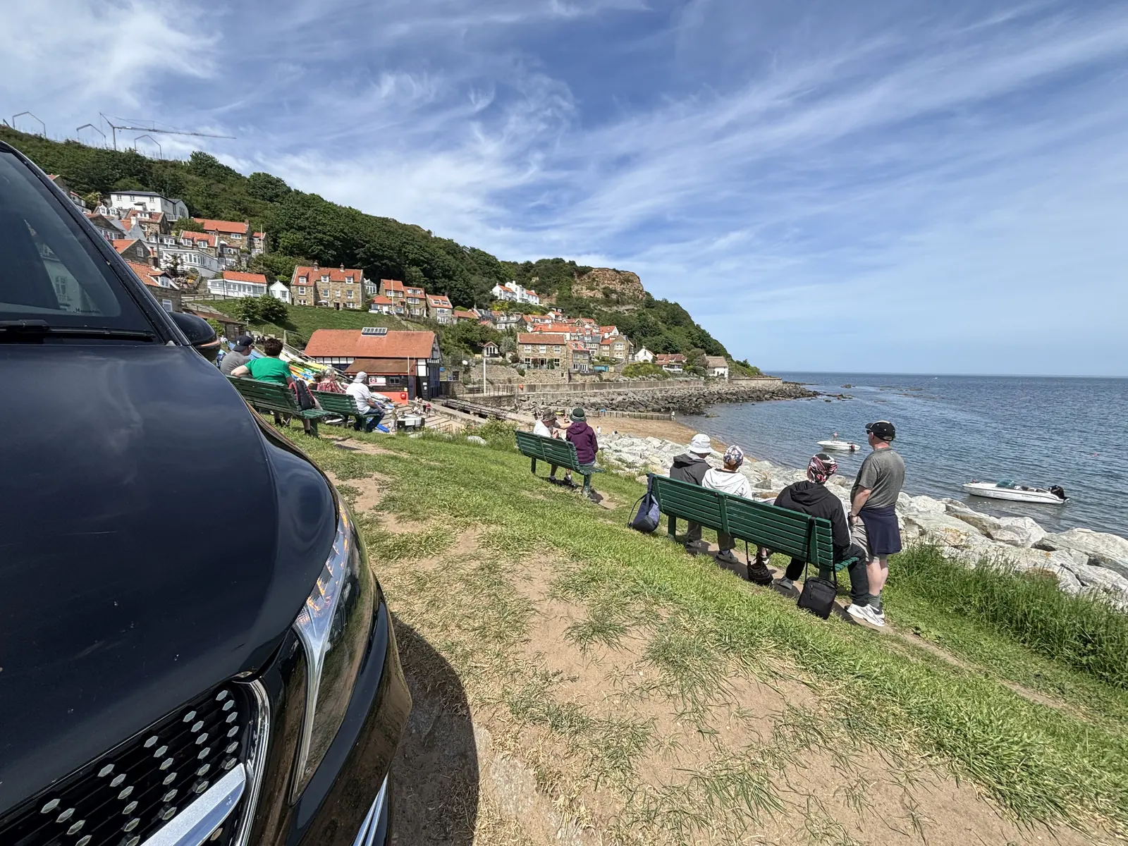 The Mercedes-Benz V-Class parked above a Yorkshire coastal village while guests take in the sea view